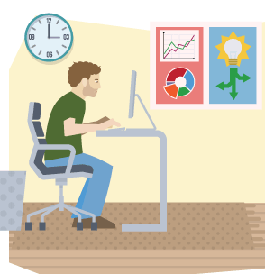 A young man sitting at a desk working on a computer.