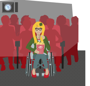 A girl in a wheelchair eating popcorn in a cinema.