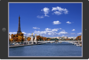 A tablet device showing a photograph of Paris in the autumn.